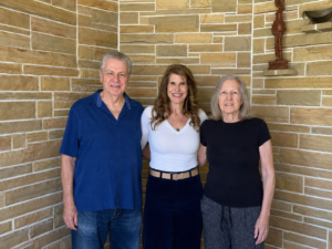 Ellen Mitchell standing on porch with her mom and dad